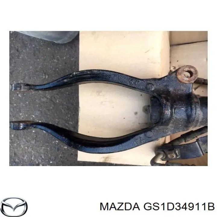 GS1D34911B Mazda Вилка нижня амортизатора переднього, ліва
