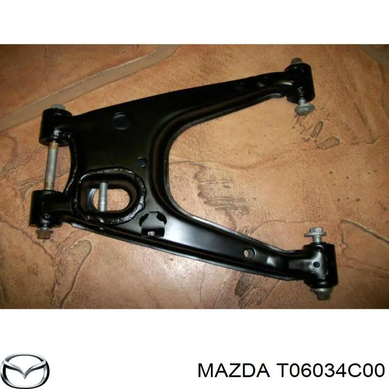 Купити T06034C00 Mazda Важіль передньої підвіски верхній, правий