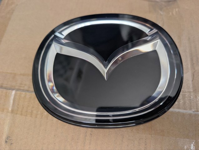 Фірмовий значок решітки радіатора BERC51730 MAZDA