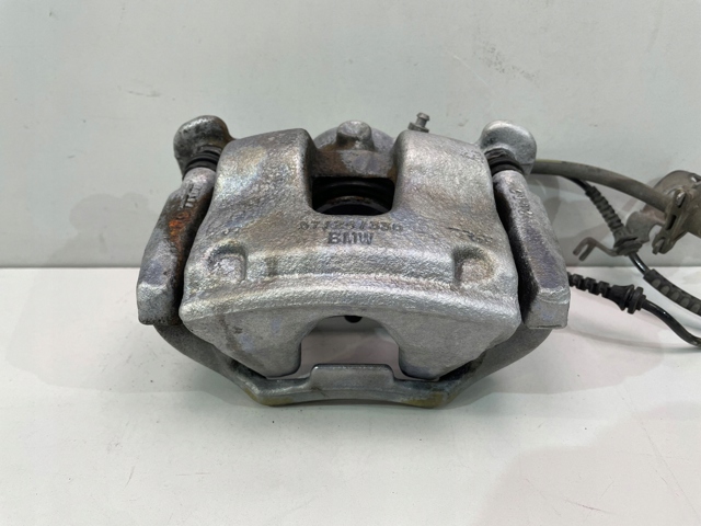 Супорт гальмівний, передній, лівий 6860267 BMW