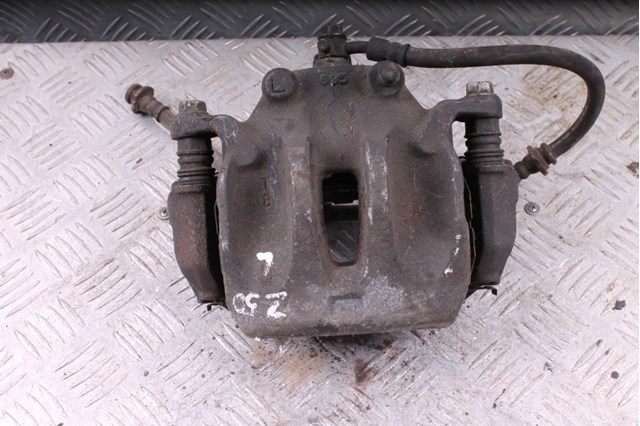 Супорт гальмівний, передній, лівий 41011CA01A NISSAN