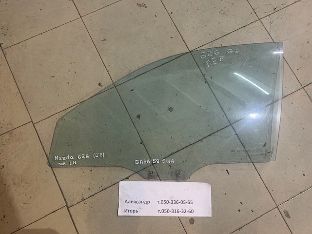 Скло водійських дверей GA8A59511A MAZDA