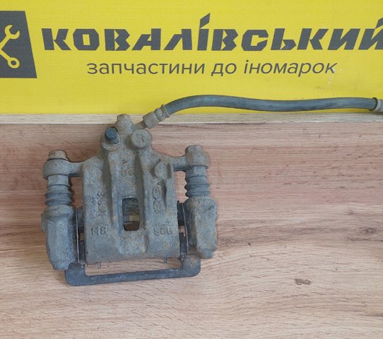 Задній гальмівний супорт лівий 58210C1150 HYUNDAI