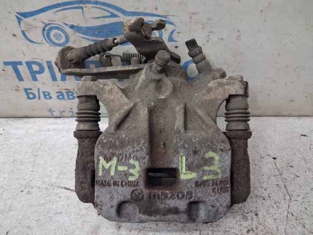 Задній гальмівний супорт лівий B4Y72699ZD MAZDA