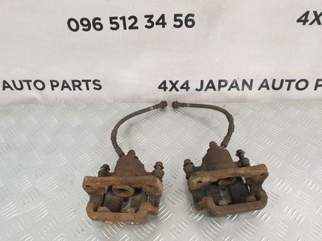 Задній гальмівний супорт лівий 44011CB10A NISSAN