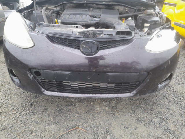 Передній бампер D65150031 Mazda