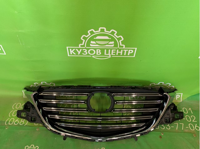 Купити TK4950710F Mazda Захисна решітка радіатора