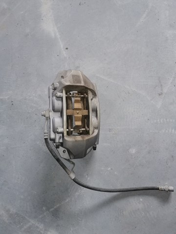 104462100D Tesla Motors Супорт гальмівний, передній, лівий