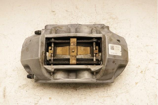 104462100D Tesla Супорт гальмівний, передній, лівий